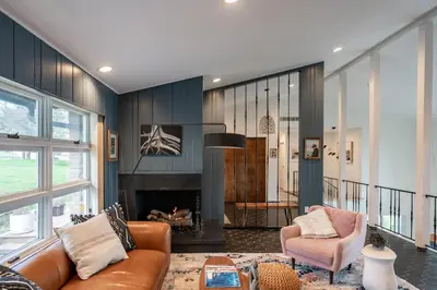 a living room with a couch and a fireplace at Hudson House in Newburgh