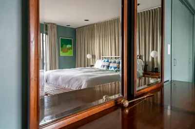 a reflection of a bedroom with a bed in a mirror at Hudson House in Newburgh