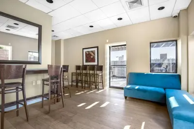 a waiting room with a blue couch and a bar at UWS 1BR w Elevator Gym nr Central Park NYC-686 in New York