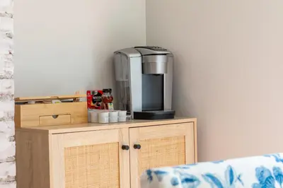 a coffee maker sitting on top of a wooden cabinet at Norwalk Retreat in Norwalk