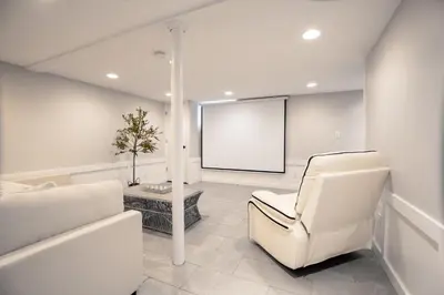 a white room with a white chair and a screen at Norwalk Retreat in Norwalk