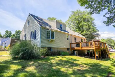 a house with a deck on the side of it at Norwalk Retreat in Norwalk