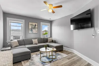a living room with a couch and a ceiling fan at Centrally Located Stamford Gem in Stamford