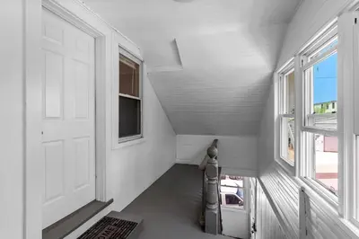 a hallway with a white door and a window at Centrally Located Stamford Gem in Stamford