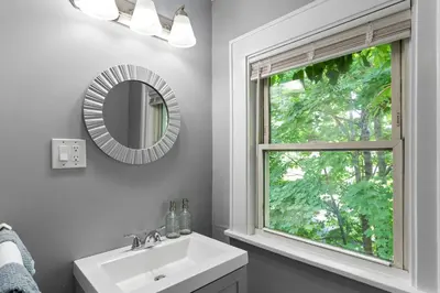 a bathroom with a sink and a mirror and a window at Centrally Located Stamford Gem in Stamford