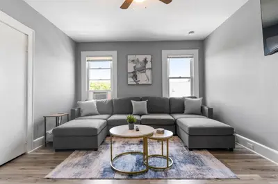 a living room with a couch and a table at Centrally Located Stamford Gem in Stamford