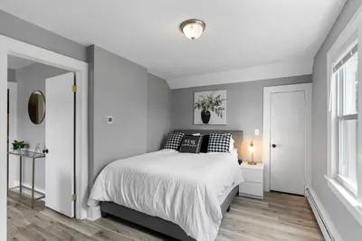 a white bedroom with a bed and a window at Centrally Located Stamford Gem in Stamford
