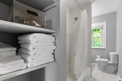 a pile of towels on a shelf in a bathroom at Centrally Located Stamford Gem in Stamford