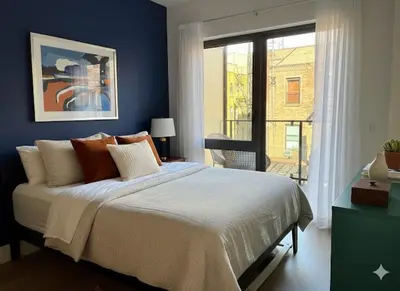 a blue bedroom with a bed and a window at Luxury in Little Italy 2 Bedroom Private Balcony in New York