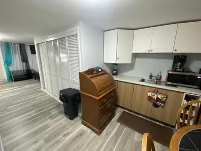a kitchen with white cabinets and a counter top at Oasis in New Jersey - 2BR NYC Access in West New York