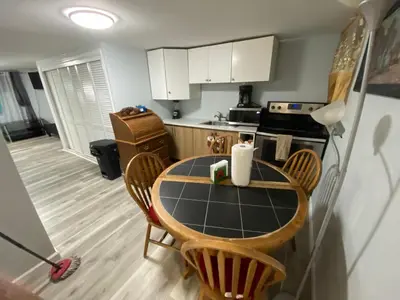 a kitchen with a table and chairs in a kitchen at Oasis in New Jersey - 2BR NYC Access in West New York