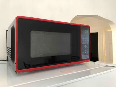 a microwave oven sitting on top of a shelf at Spacious 2-bedroom apartment with 1-bathroom and private street entrance, MetLife Stadium FIFA World Cup 25 minutes away in Paterson
