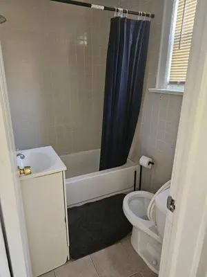 a bathroom with a tub and a toilet and a sink at Private apartment with 1 bedroom and 1 bathroom, MetLife Stadium FIFA World Cup 25 minutes away in Paterson
