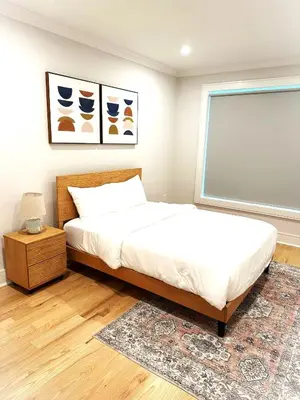 a bedroom with a bed and a window at Huge 2000 sqft Luxury & Stylish Condo minutes to New York in Jersey City