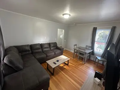 a living room with a couch and a table at Strikeout All Star Baseball Rentals in Oneonta