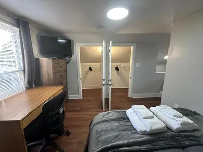 a bedroom with a desk and a bed with two towels at Strikeout All Star Baseball Rentals in Oneonta
