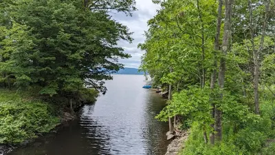 a river with trees on the side of it at Adirondack Spirit in Gloversville