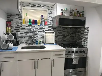 a kitchen with a sink and a stove at 25-30 mins to Times Sq! in Corona
