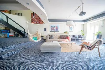 a living room with a couch and a staircase at Private Gramercy TownHouse 3BR 3BA with Terrace in New York