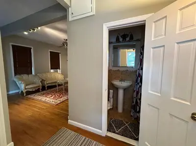 a room with a bathroom with a sink and a mirror at Stunning 4BR home close to NYC in Teaneck