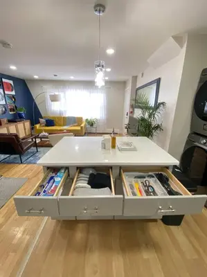 a table in a living room with a table at Live in NYC -20 Mins to Rockefeller, MoMA & World in Jersey City