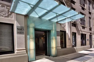 a glass entrance to a building on a city street at 73-703 New Studio UWS Doorman Gym in New York