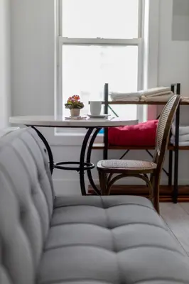 a table and a couch with a table and chairs at Manhattan Bridge-Brooklyn-UN Private Suite Bath in Brooklyn