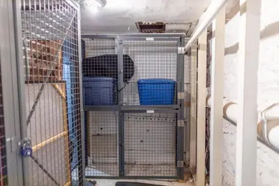 a dog in a cage in a room at Manhattan Bridge-Brooklyn-UN Private Suite Bath in Brooklyn