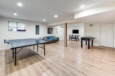 a living room with a ping pong table at Cozy Wooded Retreat Big Bass Lake Home in Lehigh