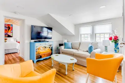 a living room with a couch and a tv at 2BR Flat above Historic Cider Mill in Westport