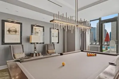 a pool table in a room with at Global Luxury Suites Downtown Jersey City in Jersey City