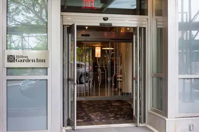 an entrance to a building with a revolving door at Hilton Garden Inn Long Island City in Queens