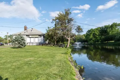 a house with a pond in front of it at Luxury Apt in Passaic