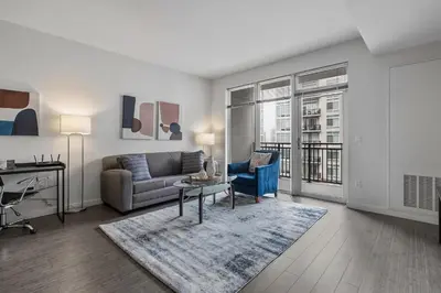 a living room with a couch and a table at Luxury Apt In Harbor Point with Balcony in Stamford