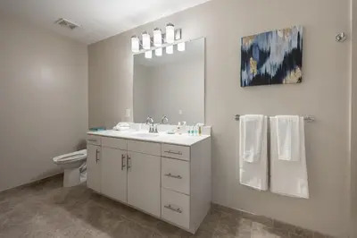 a white bathroom with a sink and a toilet at Luxury Apt In Harbor Point with Balcony in Stamford