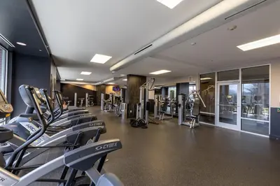 a gym with treadmills and ellipticals in a building at Luxury Apt In Harbor Point with Balcony in Stamford