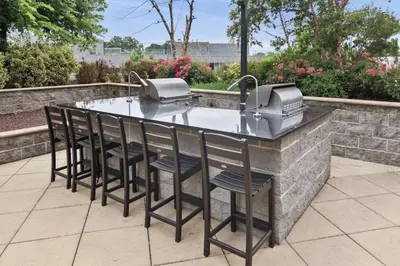 a outdoor bar with stools and a sink at Luxury Apt In Harbor Point with Balcony in Stamford