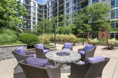 a patio with chairs and a table with purple cushions at Luxury Apt In Harbor Point with Balcony in Stamford