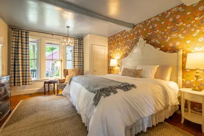 a bedroom with a large white bed in a room at Wilder House Berkshires in Sheffield