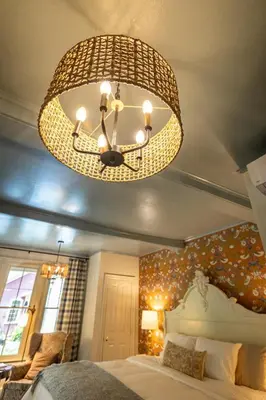 a bedroom with a large chandelier above a bed at Wilder House Berkshires in Sheffield