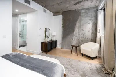 a bedroom with a bed and a mirror and a chair at Luxury Full Floor Chelsea Apt St 7 in New York