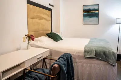 a bedroom with a bed and a desk with a chair at Mansfield in New York