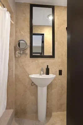 a bathroom with a sink and a mirror at Mansfield in New York