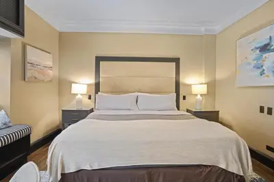 a bedroom with a large bed with two lamps on both sides at Mansfield in New York