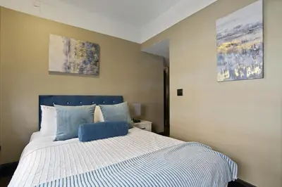 a bedroom with a bed and two paintings on the wall at Mansfield in New York