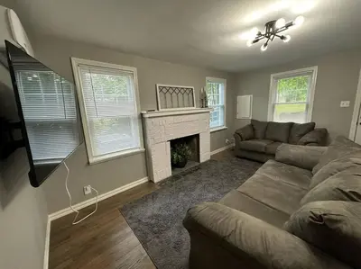 a living room with a couch and a fireplace at 3BR, 2BA and Office Fire Pit,Mins 2 UConn & Lake in Coventry