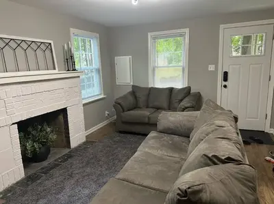 a living room with a couch and a fireplace at 3BR, 2BA and Office Fire Pit,Mins 2 UConn & Lake in Coventry