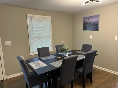 a dining room with a black table and chairs at 3BR, 2BA and Office Fire Pit,Mins 2 UConn & Lake in Coventry