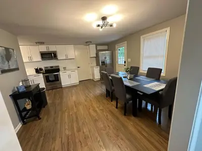 a dining room and kitchen with a table and chairs at 3BR, 2BA and Office Fire Pit,Mins 2 UConn & Lake in Coventry