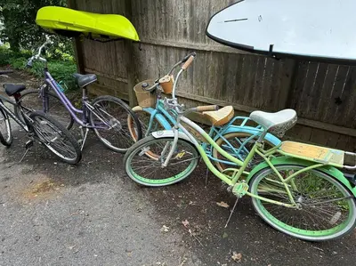 three bikes parked next to a fence with a surfboard at 3BR, 2BA and Office Fire Pit,Mins 2 UConn & Lake in Coventry